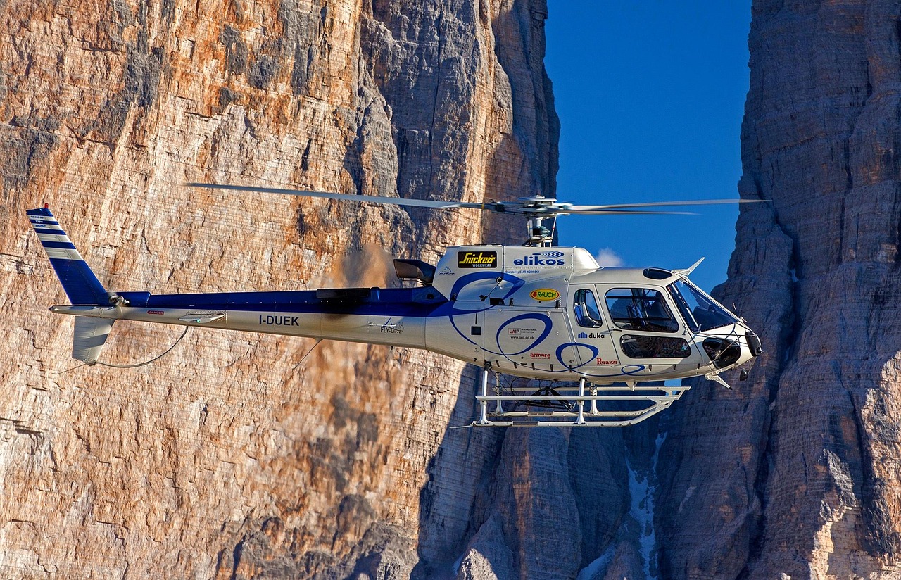 Helicopter flying beside a mountain cliff representing Aircraft lease programs, aviation lease financing, used helicopter financing, Cessna refinance loan, and airplane leasing solutions for private aviation, commercial operators, and aviation business growth.