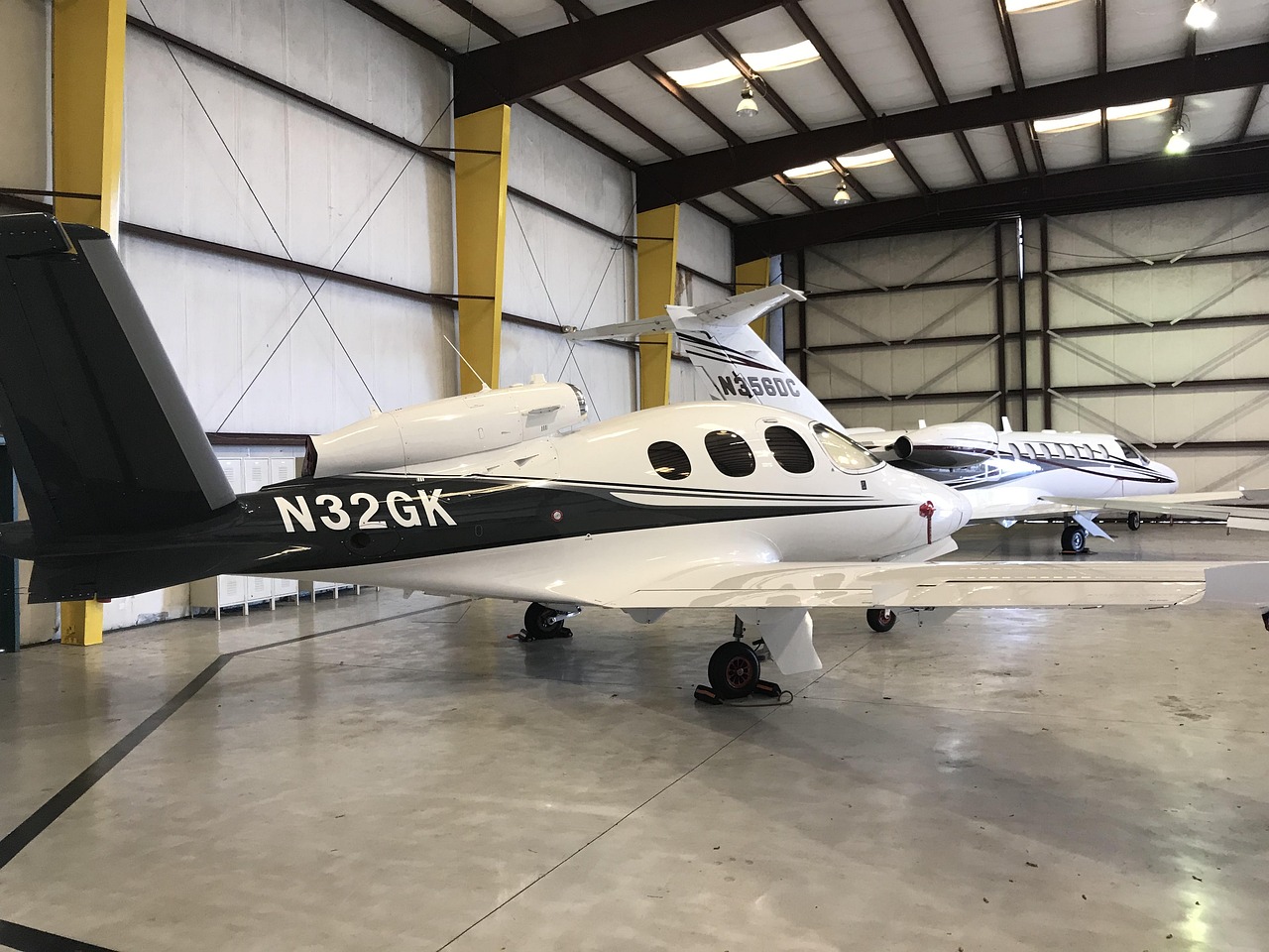 Private aircraft stored inside a modern aviation hangar, illustrating Aircraft Shelter Financing, aviation property financing, small private jet financing, light business jet loans, and private jet ownership funding for aircraft owners seeking hangar construction, aviation real estate, and aircraft acquisition financing solutions.