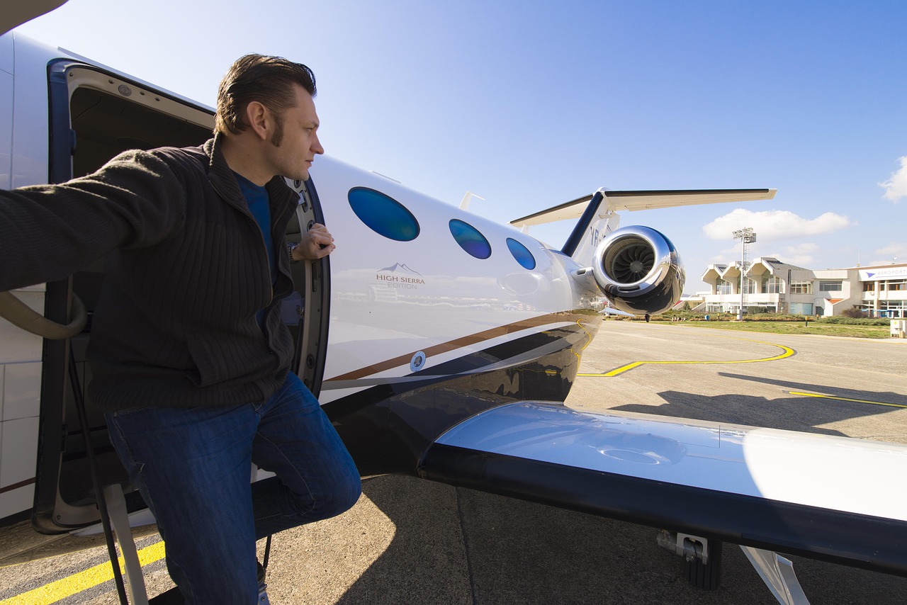 Business executive stepping out of a private jet on an airport tarmac, illustrating company jet financing, Jet acquisition financing, airplane ownership funding, aircraft acquisition funding, and aircraft purchase financing solutions for corporate and private aviation buyers.