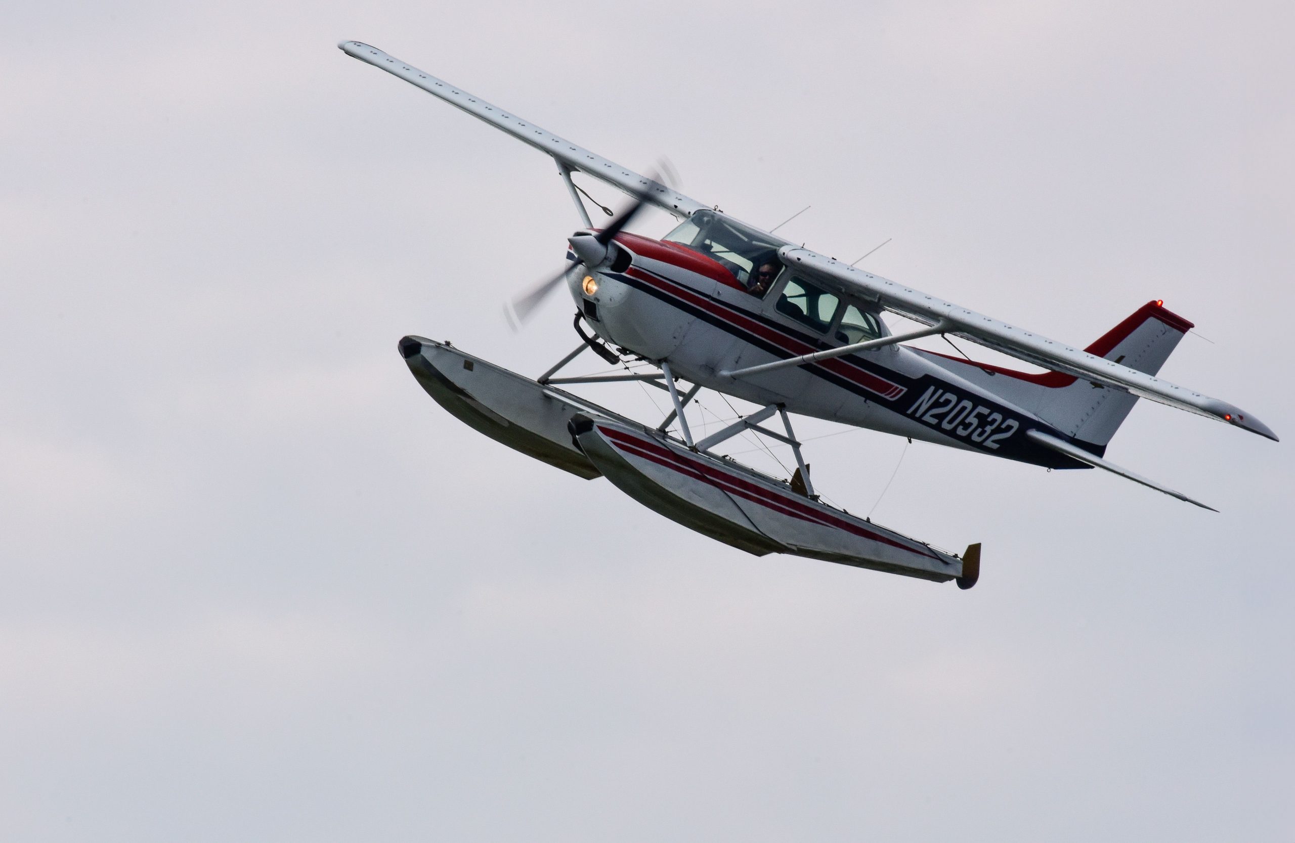 Float-equipped Cessna aircraft flying over open skies, illustrating Cessna financing, Cessna equity loan, aircraft refinance Cessna, financing a Cessna 150, and aircraft loans for Cessnas for pilots, flight schools, and aviation enthusiasts.