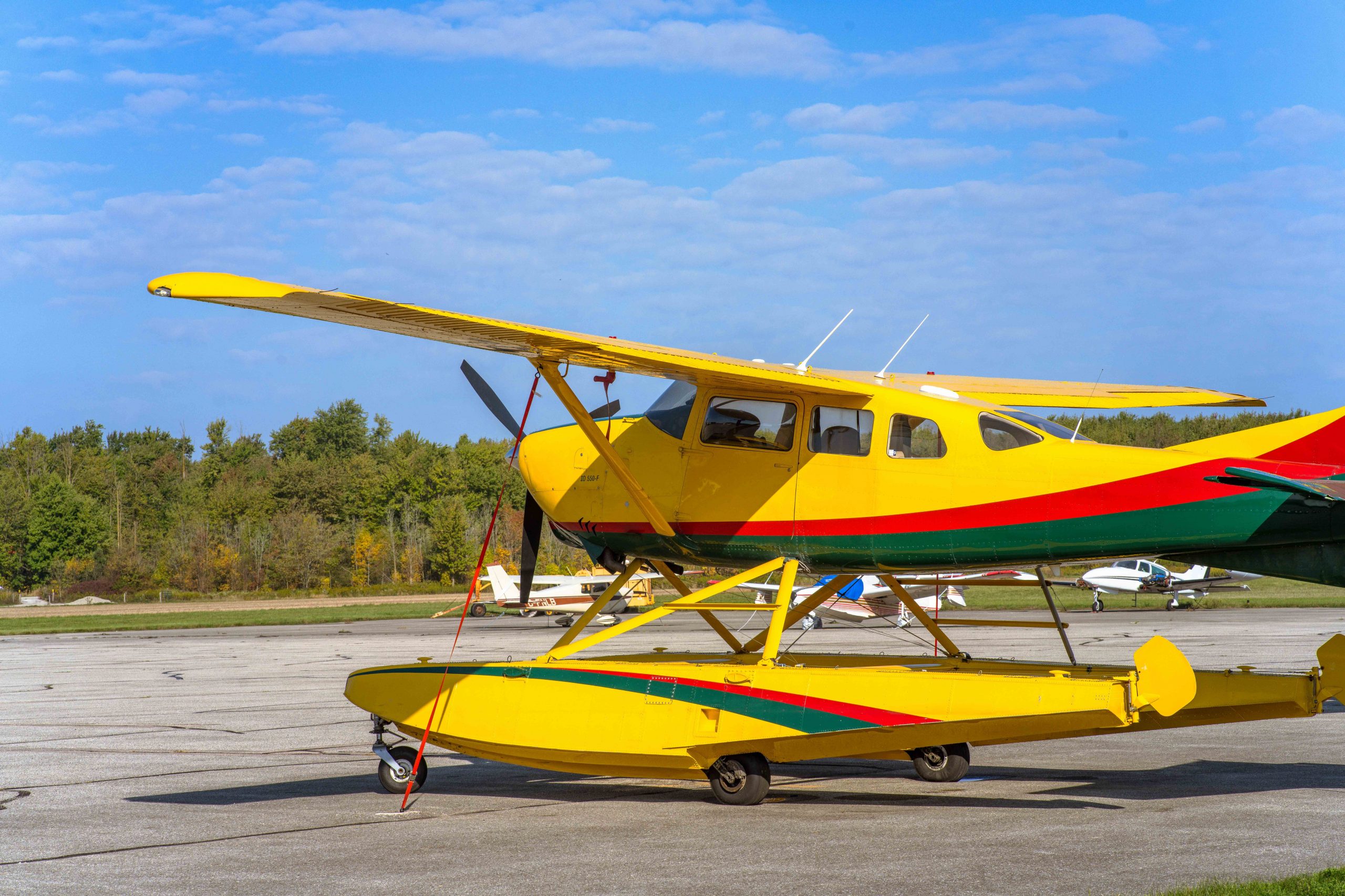 Yellow float-equipped aircraft parked on an airport ramp, representing Turbine helicopter loans, Bombardier jet financing, aircraft enhancement financing, aircraft maintenance financing, and aircraft repair financing for aviation owners, operators, and aircraft investors.