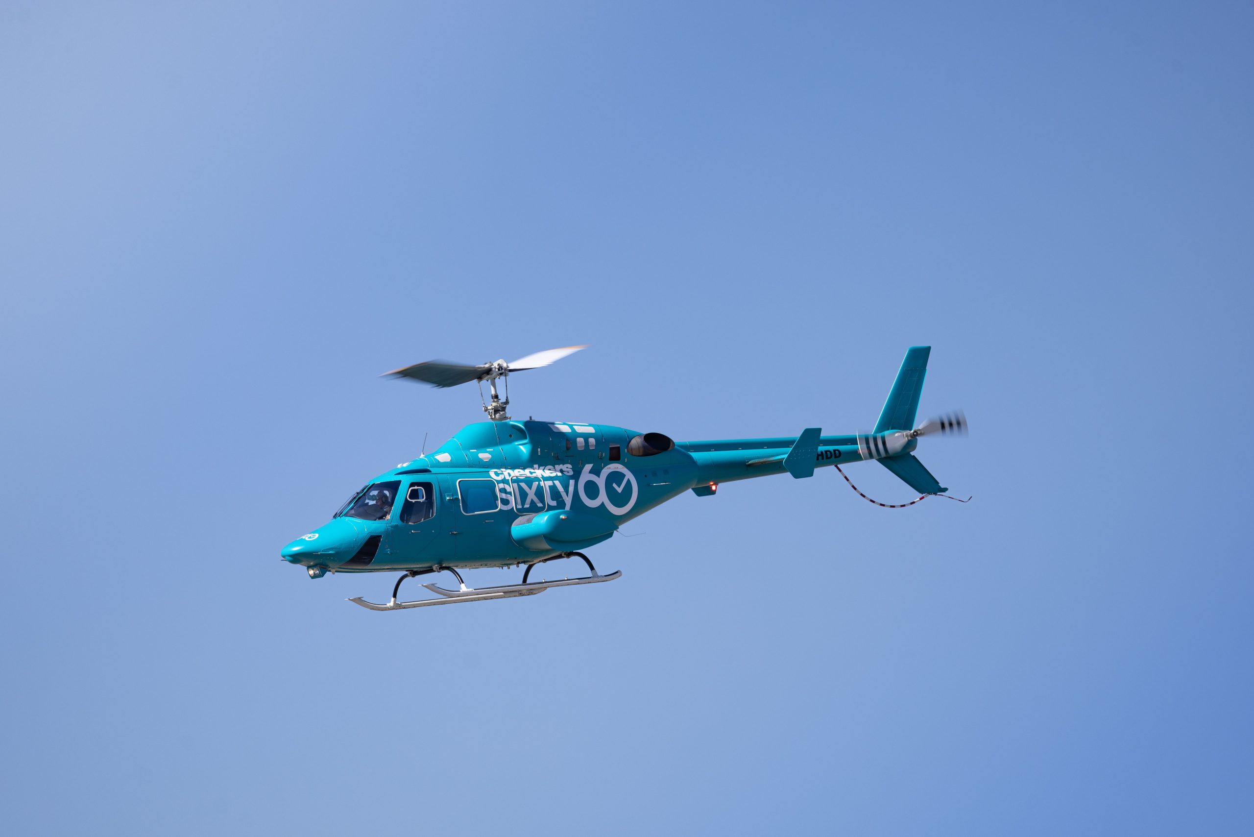 Blue helicopter flying against a clear sky representing Gulfstream Financing, Cessna 182 aircraft loans, jet financing specialists, aircraft lenders, and opportunities to apply for aircraft financing for helicopters, airplanes, business jets, and private aviation ownership.